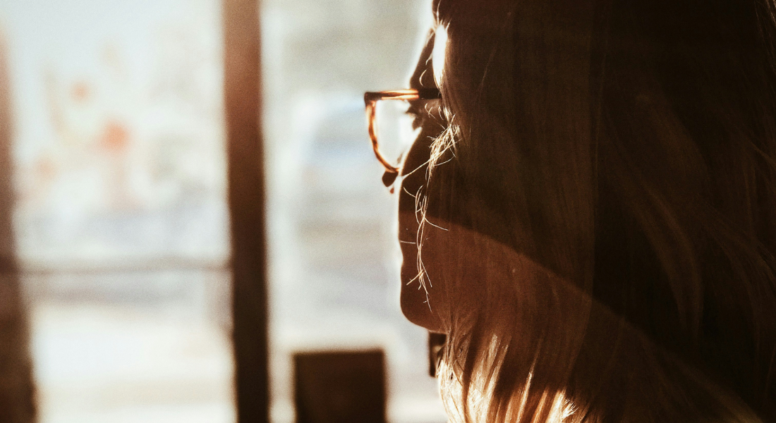 close up of a women staring out a window